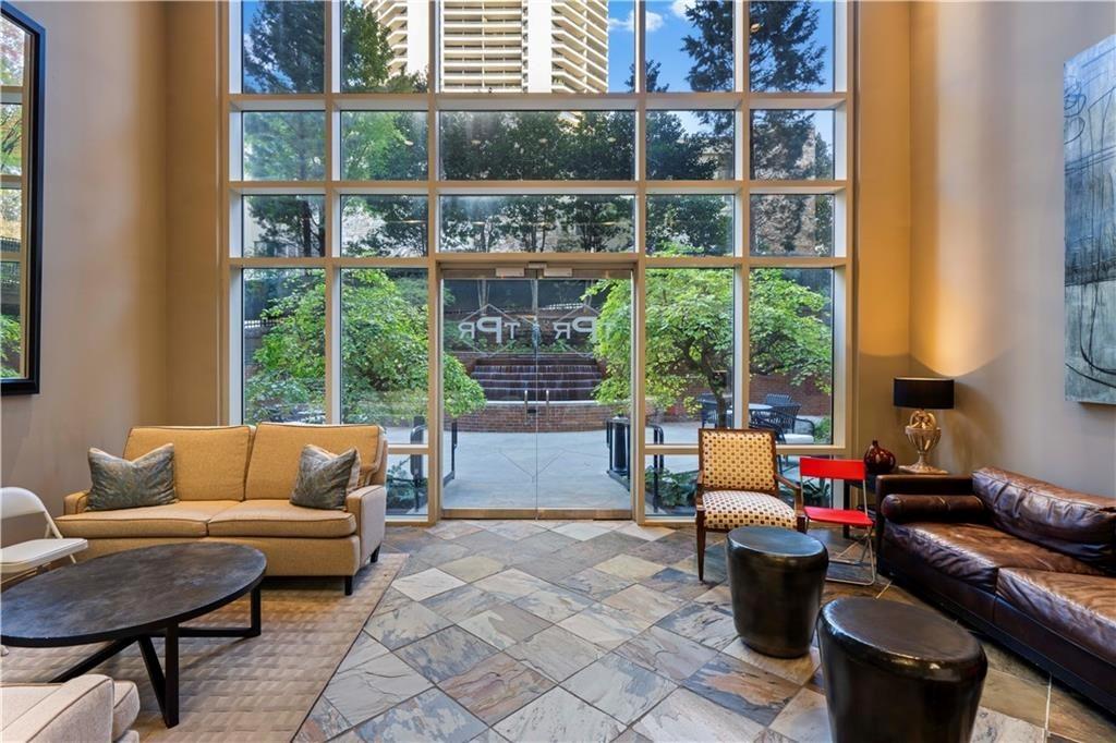 2626 Peachtree Road Northwest, Unit 704 Atlanta, GA 30305 - Photo 17 of 23 a living room with furniture and a window