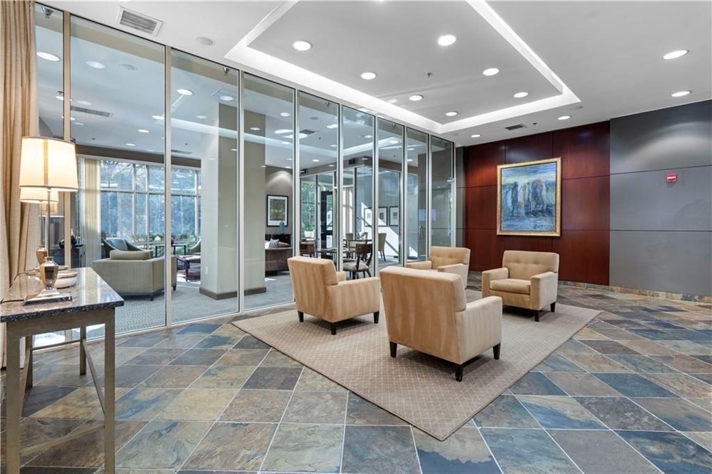 2626 Peachtree Road Northwest, Unit 704 Atlanta, GA 30305 - Photo 3 of 23 a living room with furniture and large windows