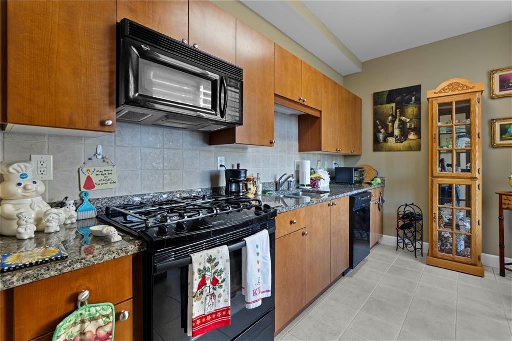 2626 Peachtree Road Northwest, Unit 704 Atlanta, GA 30305 - Photo 5 of 23 a kitchen with stainless steel appliances granite countertop a stove and cabinets