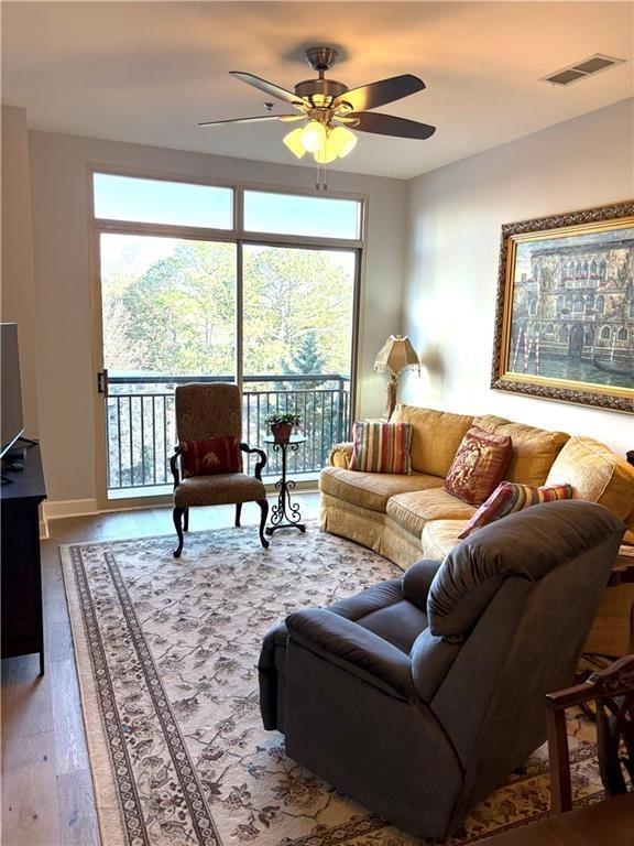 2626 Peachtree Road Northwest, Unit 704 Atlanta, GA 30305 - Photo 9 of 23 a living room with furniture a rug and a large window