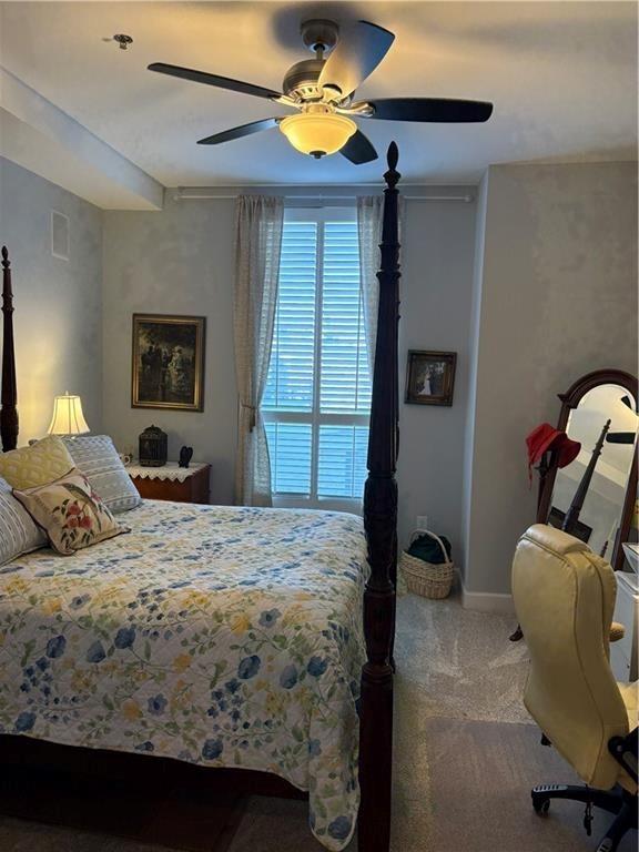 2626 Peachtree Road Northwest, Unit 704 Atlanta, GA 30305 - Photo 10 of 23 a bedroom with a bed and a chandelier