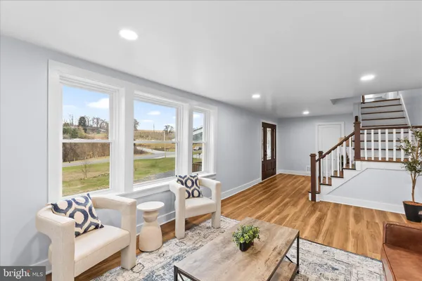 a living room with furniture and floor to ceiling windows