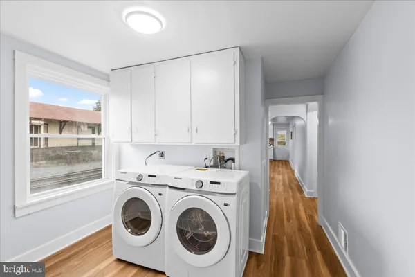 a view of a hallway with washer and dryer