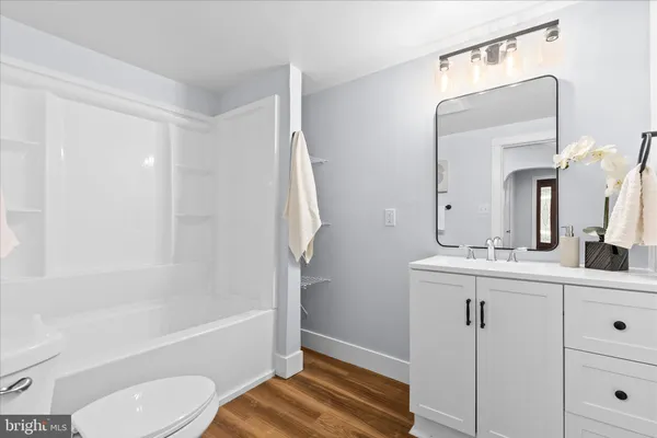 a bathroom with a bathtub a sink and a mirror