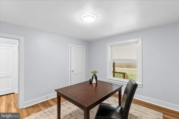 a view of a room with a table and chairs