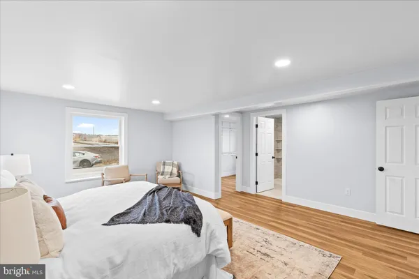 a bedroom with a large bed and a window