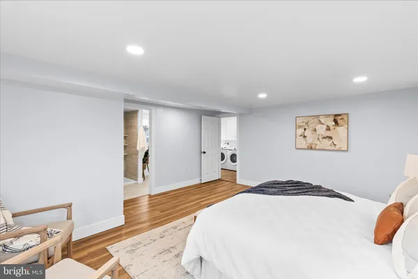 a bedroom with a bed and a wooden floor