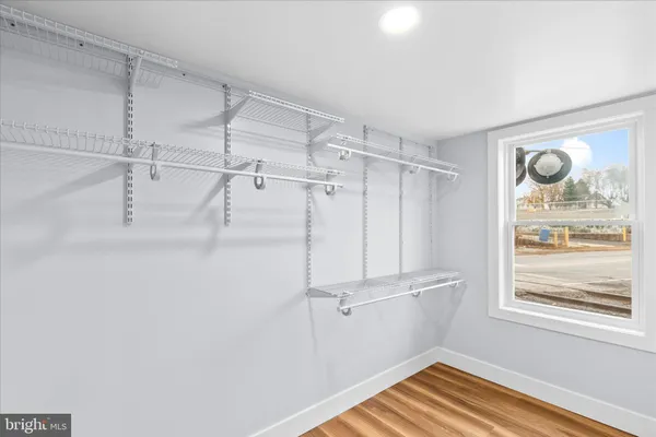 a view of a room with rack on the wall and a window