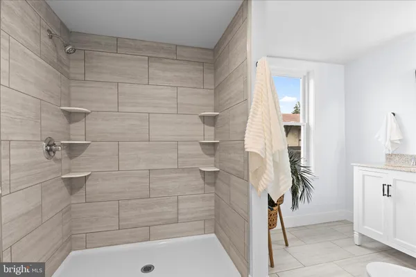a bathroom with a shower and a sink