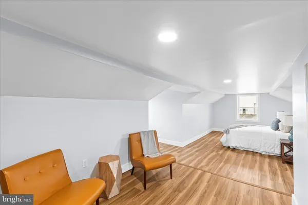 a bedroom with a bed and chair