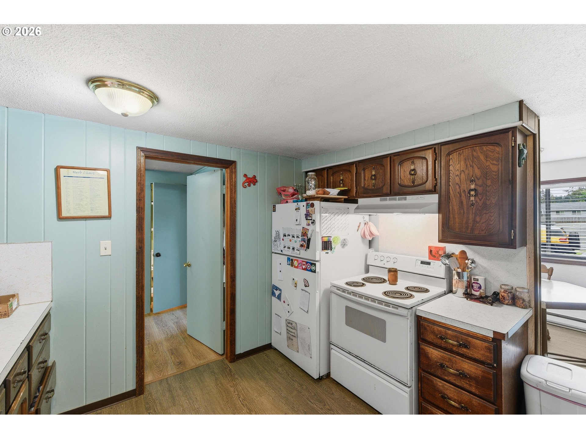 1955 Maple Street North Bend, OR 97459 - Photo 15 of 48 a kitchen with stainless steel appliances a white stove top oven and a refrigerator