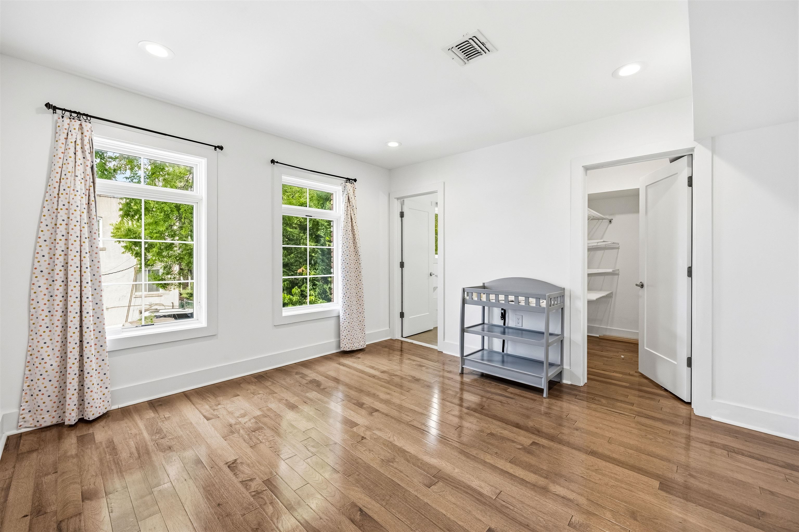107 Mountain Road Jersey City, NJ 07307 - Photo 25 of 41 a view of an empty room with a window and wooden floor