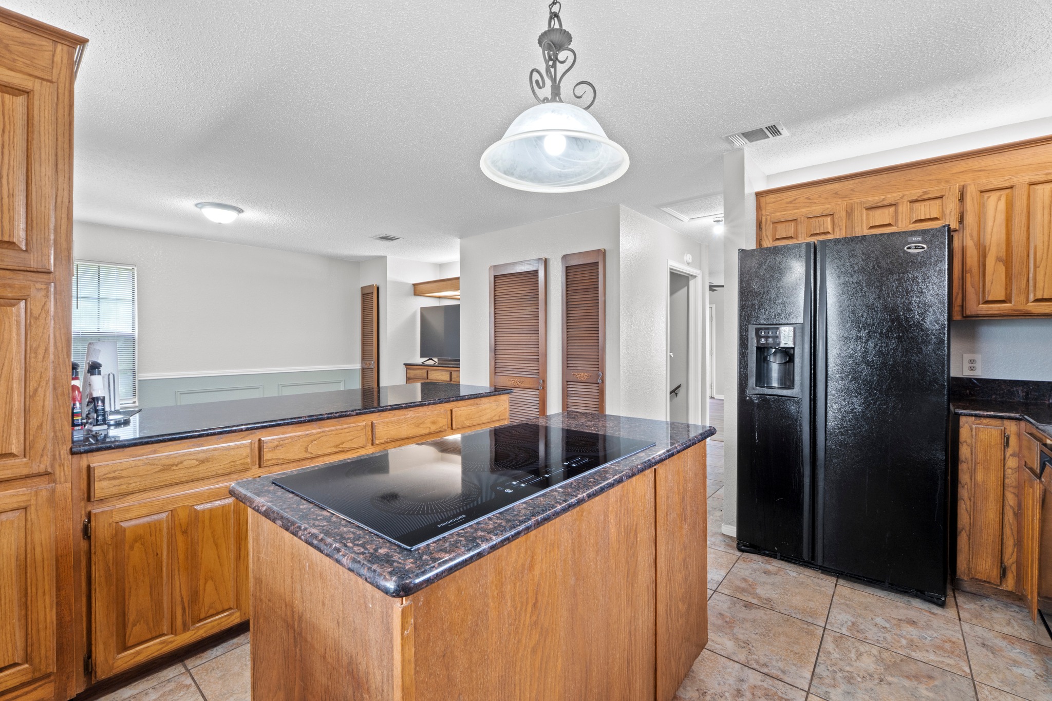 205 Sedro Trail Georgetown, TX 78633 - Photo 17 of 32 A well-appointed kitchen showcasing an island cooktop and integrated cabinetry, perfect for culinary adventures.