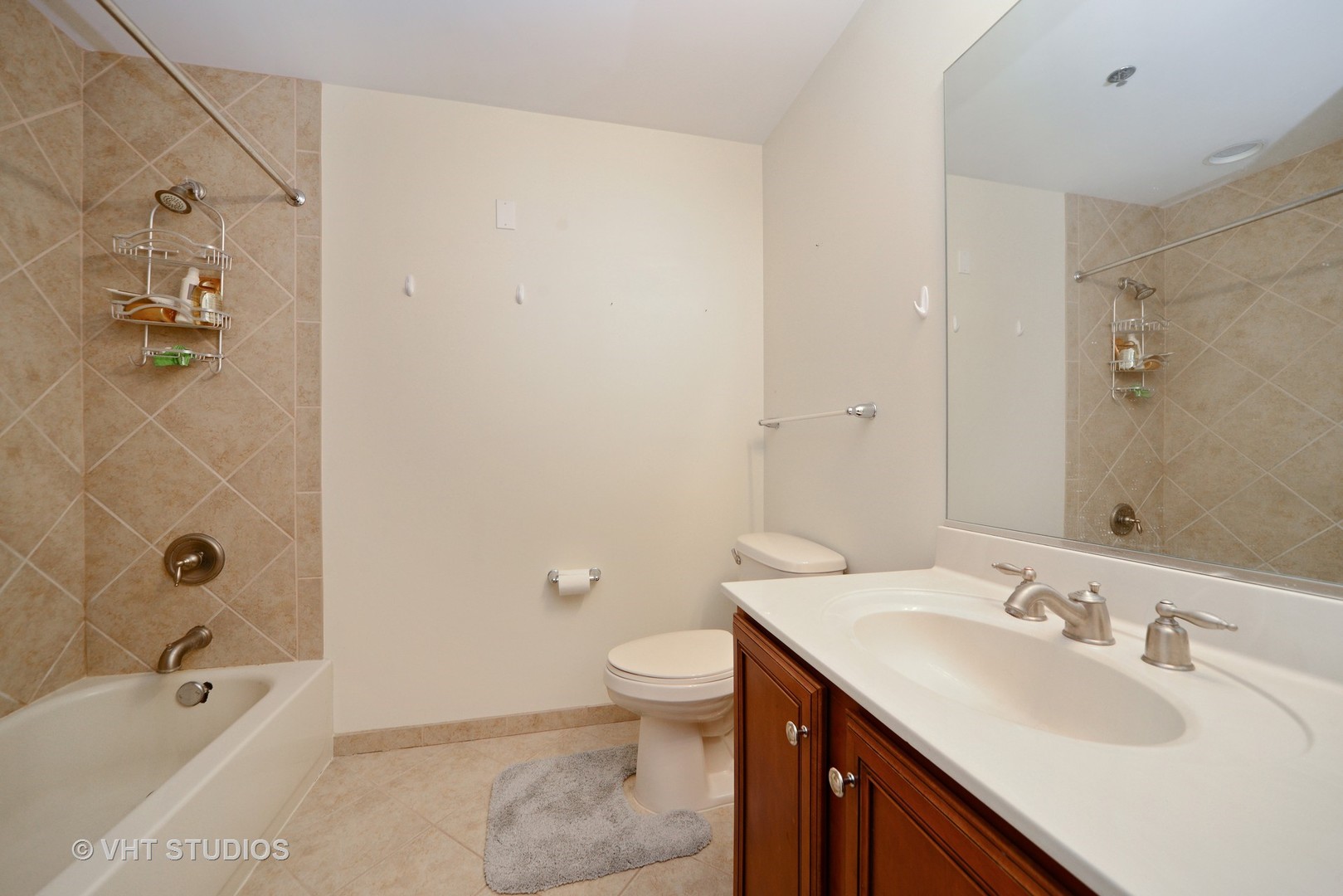 1255 South State Street, Unit 1406 Chicago, IL 60605 - Photo 6 of 9 a bathroom with a granite countertop sink a toilet and shower