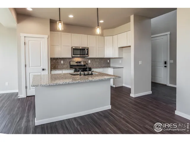 a kitchen with stainless steel appliances a refrigerator sink and microwave