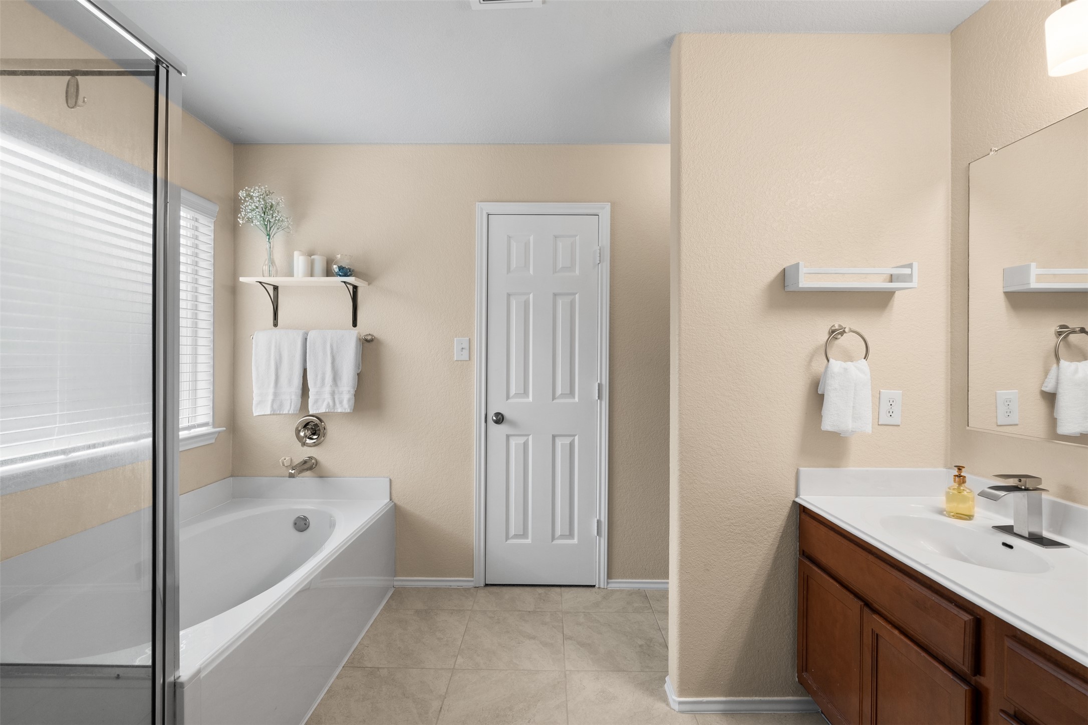 137 Barn Owl Loop Leander, TX 78641 - Photo 22 of 36 a bathroom with a tub sink and mirror