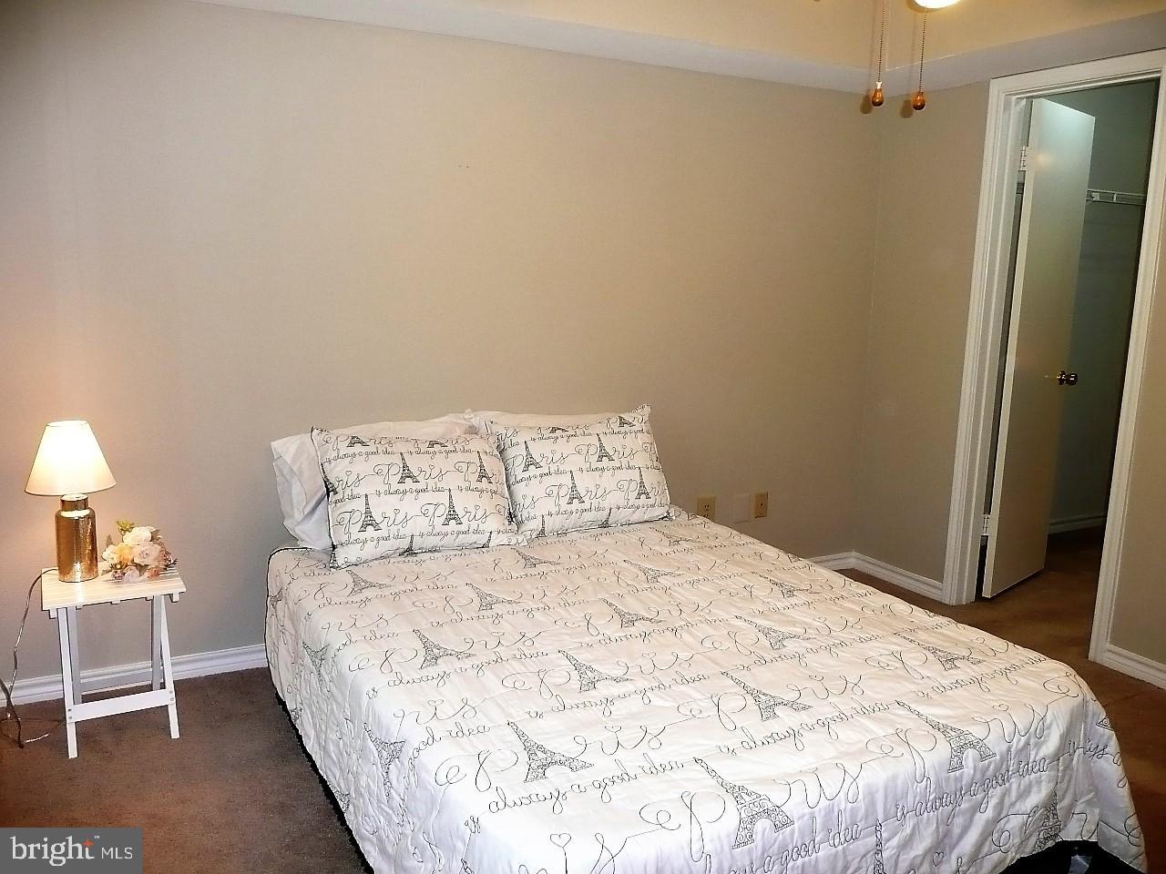 3903 Penderview Drive, Unit 1535 Fairfax, VA 22033 - Photo 15 of 36 a bedroom with a bed and a night stand