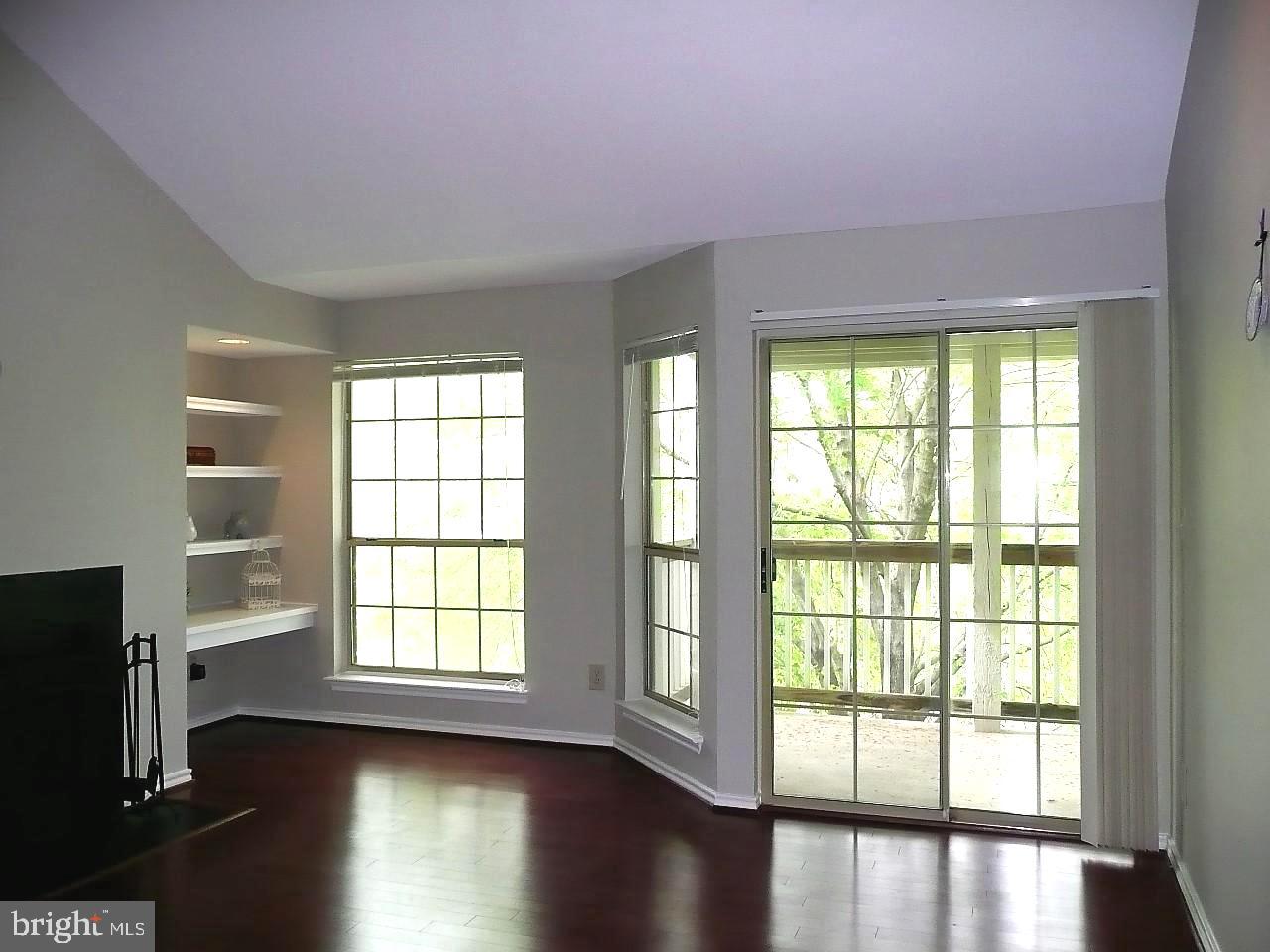 3903 Penderview Drive, Unit 1535 Fairfax, VA 22033 - Photo 5 of 36 a view of an empty room with wooden floor and a window