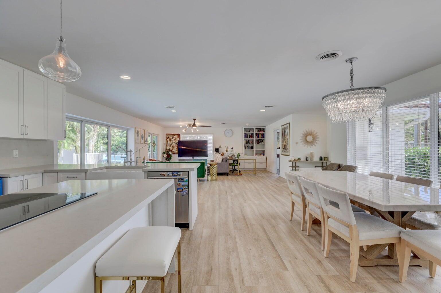 a large kitchen with kitchen island a large island in the center and stainless steel appliances