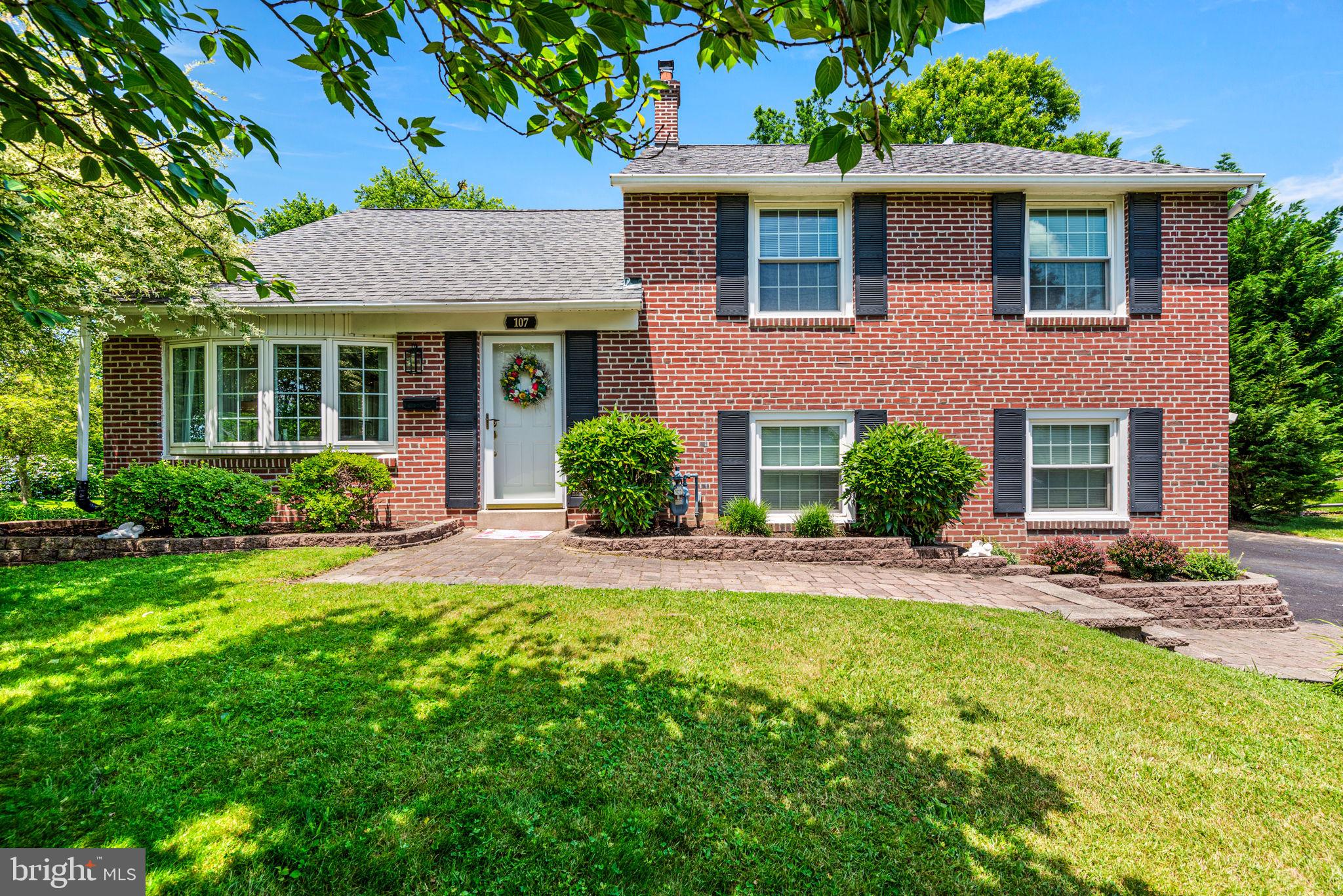 107 Lombardy Drive Wallingford, PA 19086 - Photo 1 of 36 front view of a house with a yard