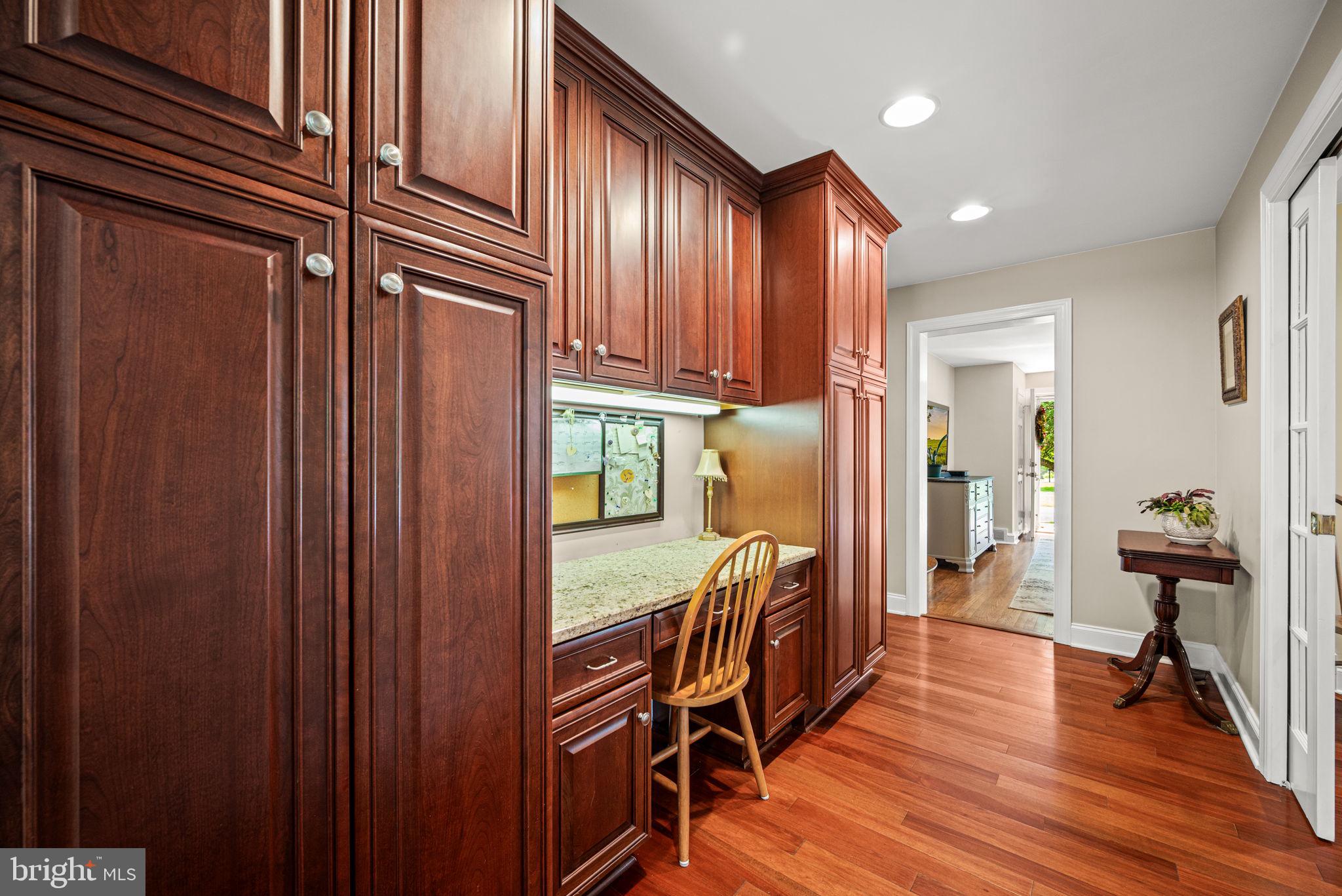 107 Lombardy Drive Wallingford, PA 19086 - Photo 11 of 36 a view of a hallway with wooden floor and furniture