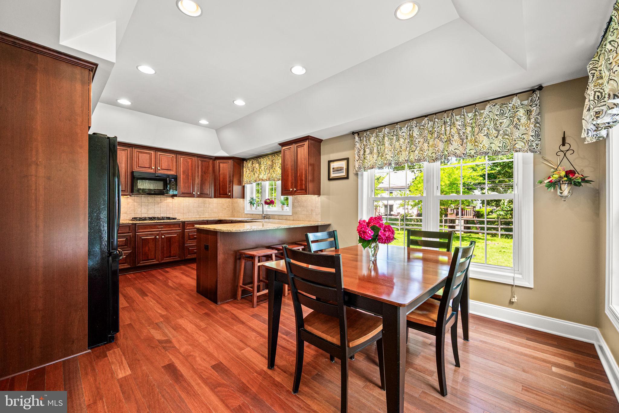 107 Lombardy Drive Wallingford, PA 19086 - Photo 12 of 36 a view of a dining room with furniture window and wooden floor