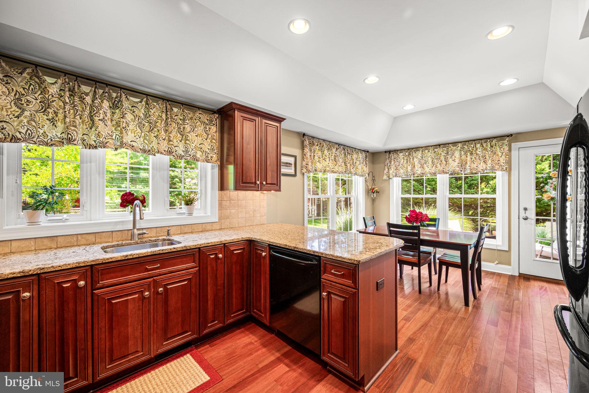 107 Lombardy Drive Wallingford, PA 19086 - Photo 15 of 36 a kitchen with a sink and wooden cabinets