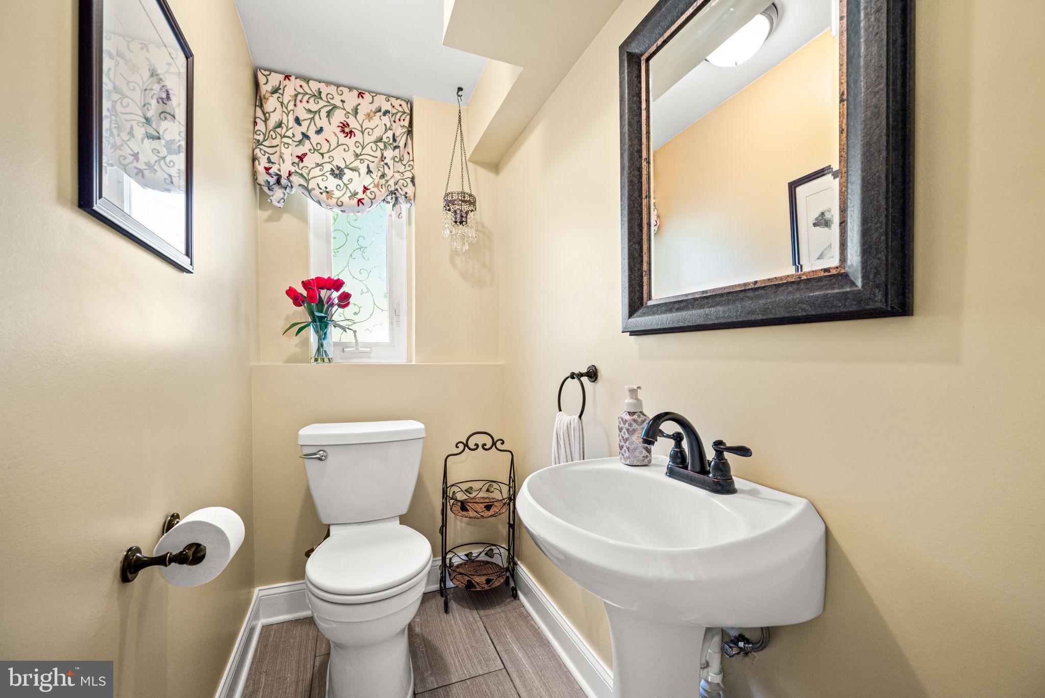 107 Lombardy Drive Wallingford, PA 19086 - Photo 18 of 36 a bathroom with a toilet sink and mirror