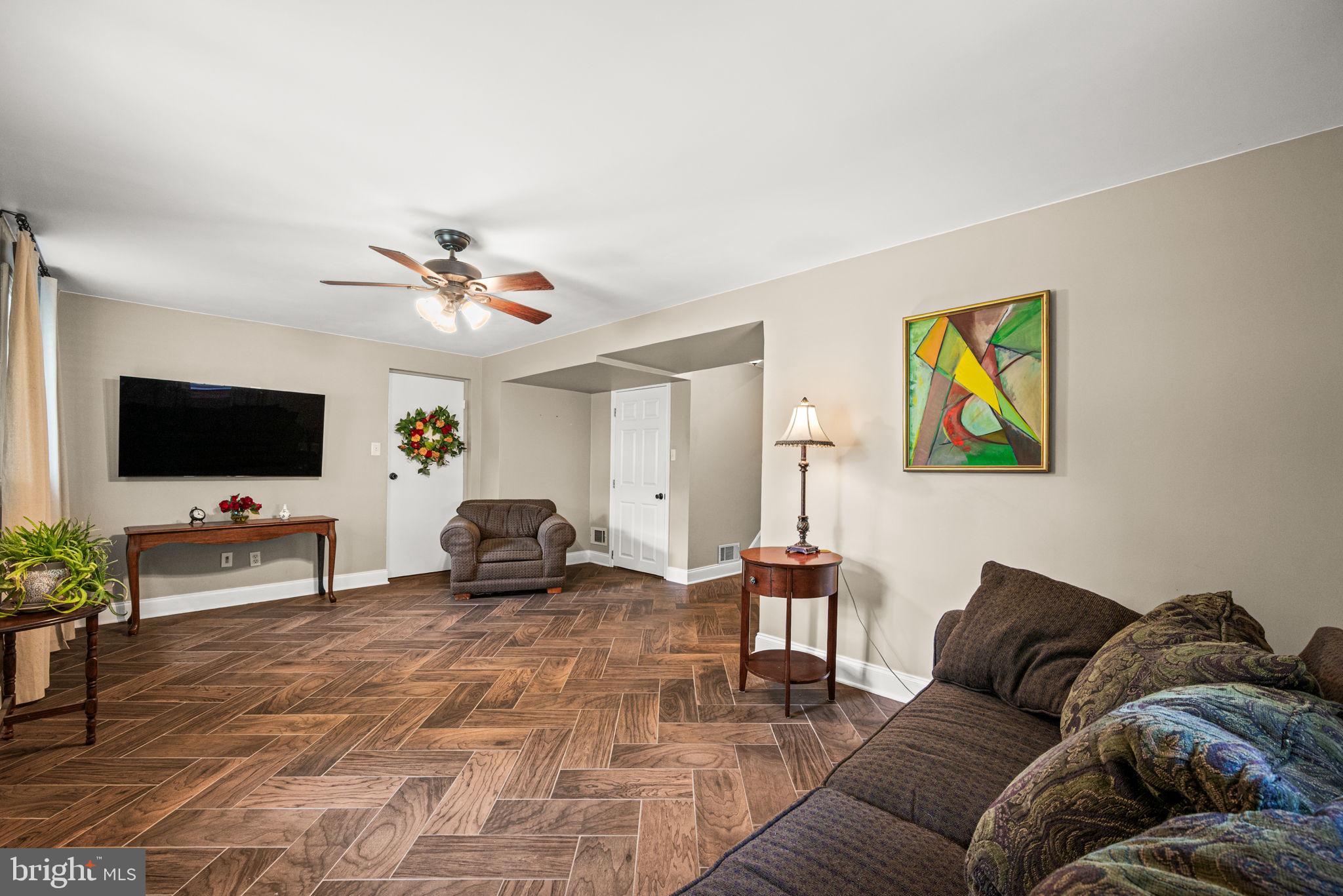 107 Lombardy Drive Wallingford, PA 19086 - Photo 20 of 36 a living room with furniture and a flat screen tv