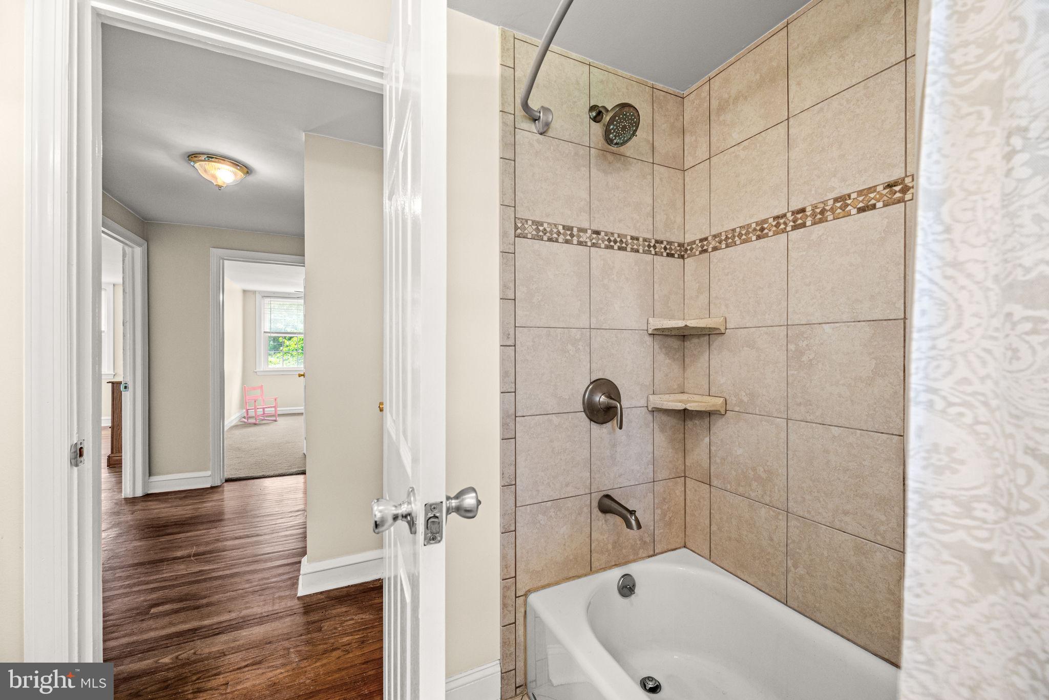 107 Lombardy Drive Wallingford, PA 19086 - Photo 25 of 36 a bathroom with a bathtub and a shower