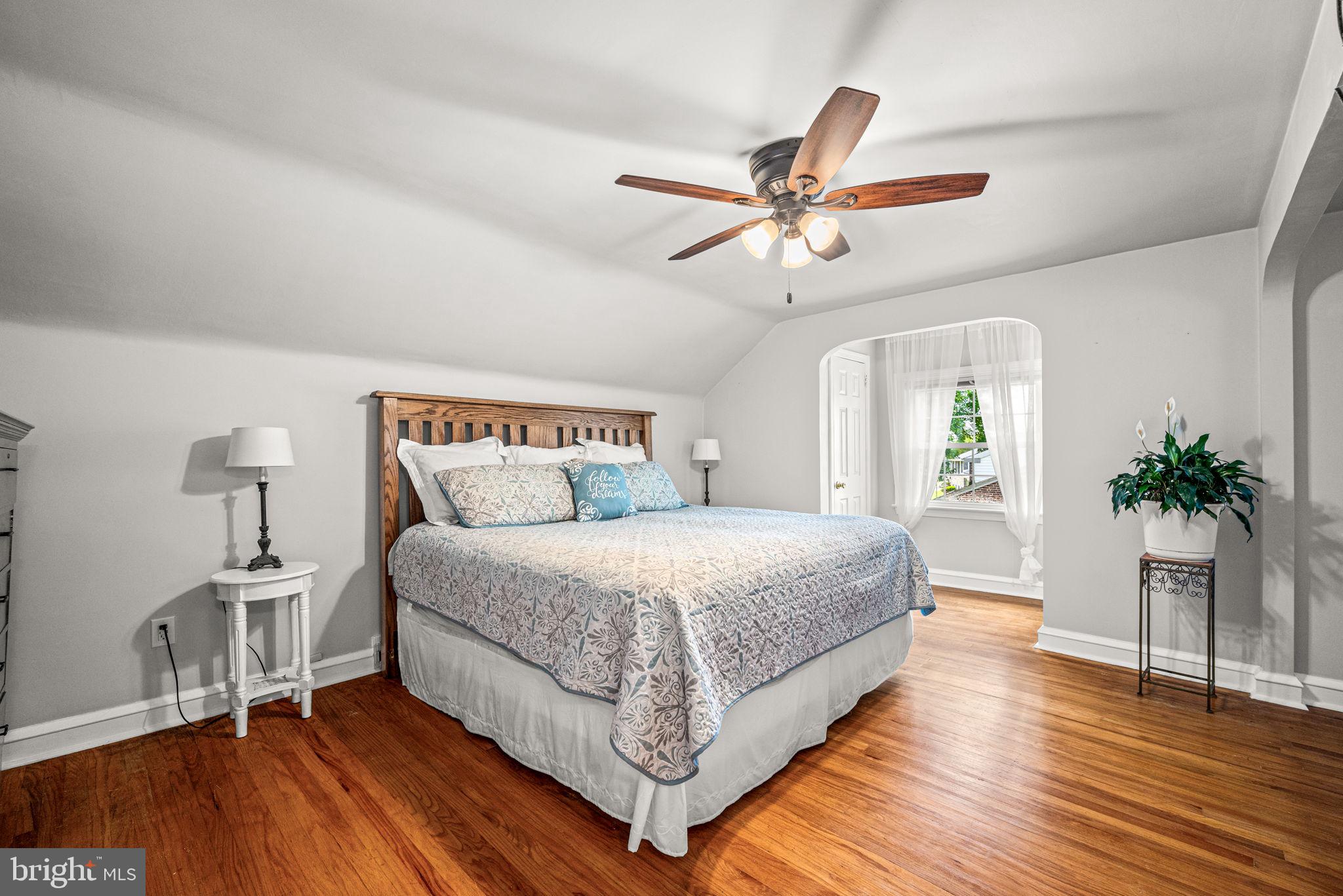 107 Lombardy Drive Wallingford, PA 19086 - Photo 27 of 36 a bedroom with a bed and a chandelier