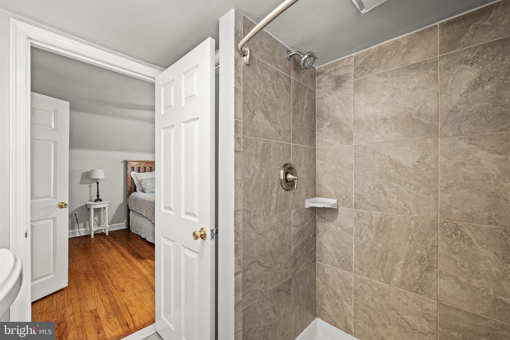 107 Lombardy Drive Wallingford, PA 19086 - Photo 31 of 36 a bathroom with a shower and a sink