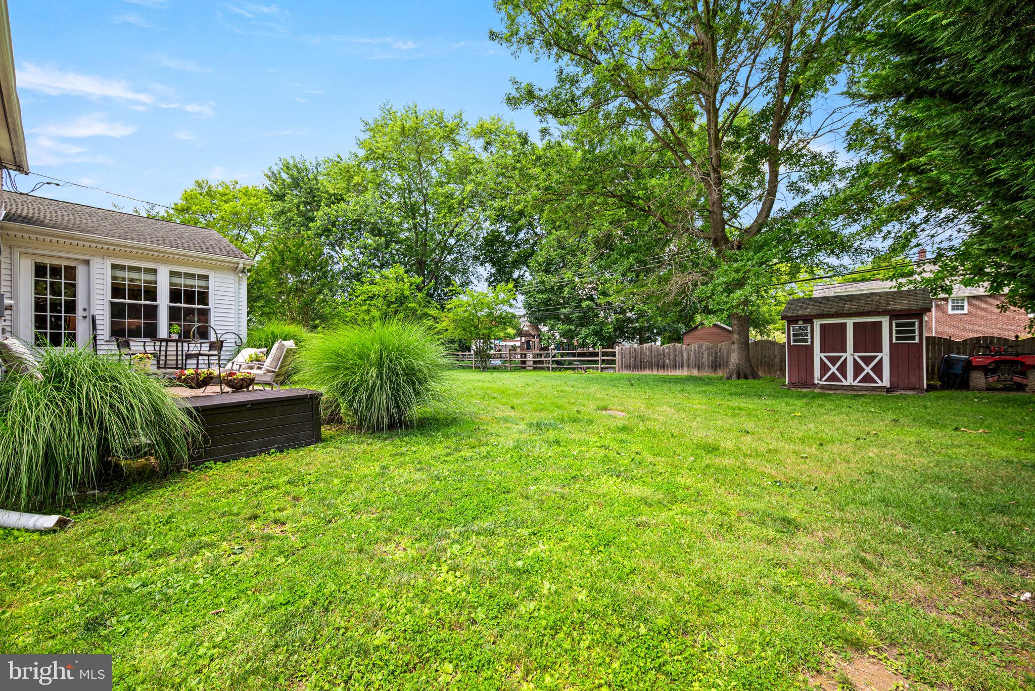 107 Lombardy Drive Wallingford, PA 19086 - Photo 32 of 36 a house view with a sitting space and garden