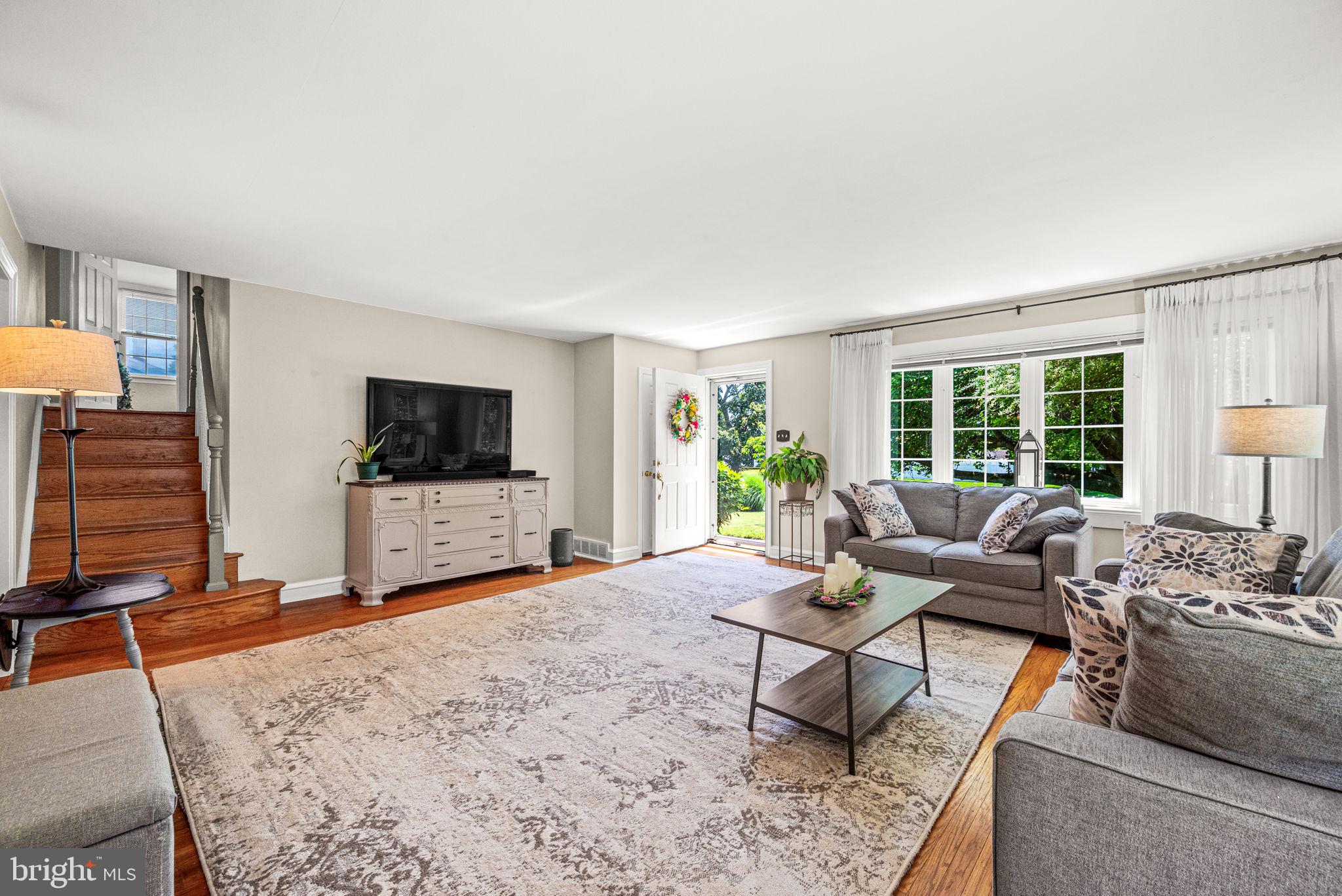 107 Lombardy Drive Wallingford, PA 19086 - Photo 6 of 36 a living room with furniture and a flat screen tv