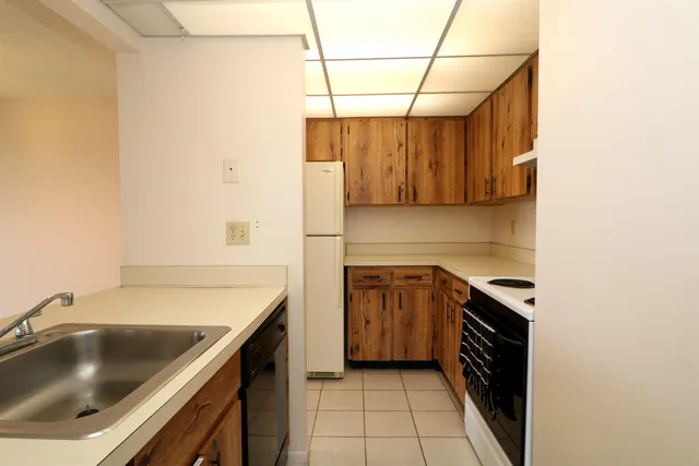 a kitchen with a sink and refrigerator