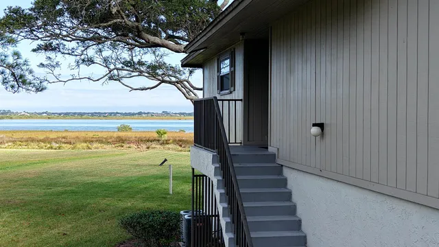 a view of an ocean with a floor to ceiling window and yard