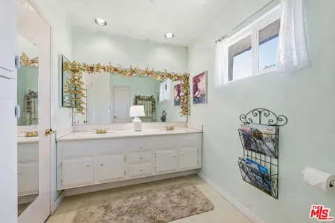 a bathroom with a sink a mirror and a shower