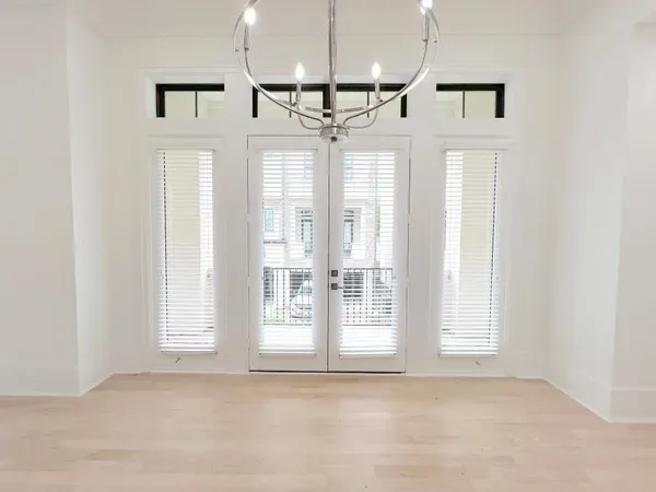 a view of entryway and kitchen with a ceiling fan