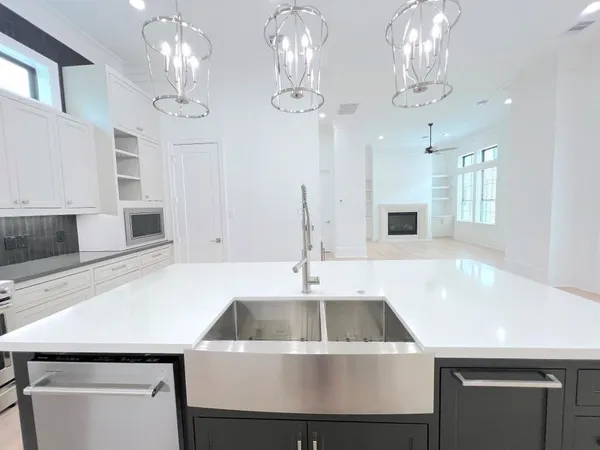 a kitchen with a sink a counter space and cabinets