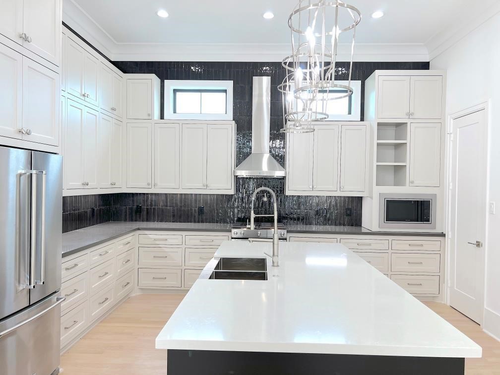 2122 Blalock Road, Unit C Houston, TX 77080 - Photo 14 of 45 a kitchen with kitchen island granite countertop a sink cabinets and stainless steel appliances