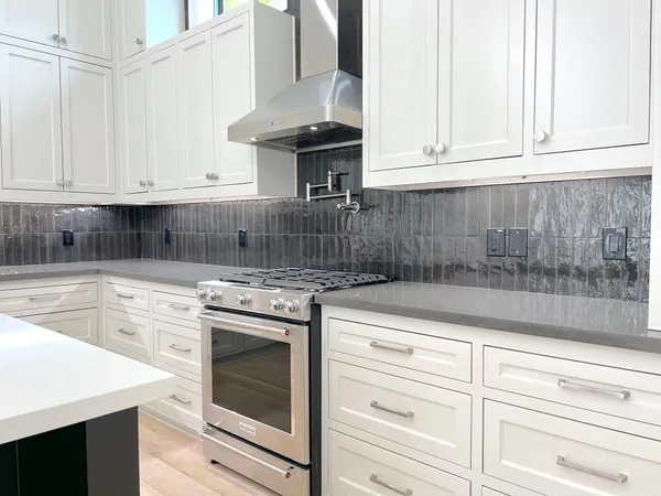 a kitchen with granite countertop white cabinets and white appliances