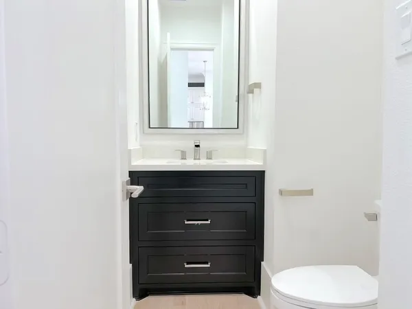 a view of an empty room with chandelier and a window