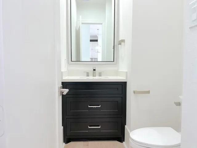 a view of an empty room with chandelier and a window
