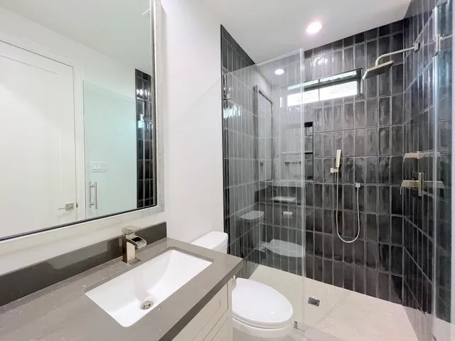 a view of a backyard with brick wall and potted plants