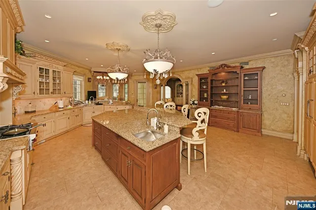 a large kitchen with a table and chairs
