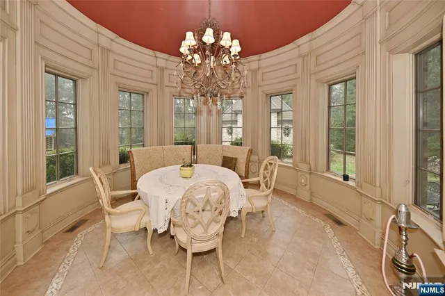 a view of a dining room with furniture and chandelier