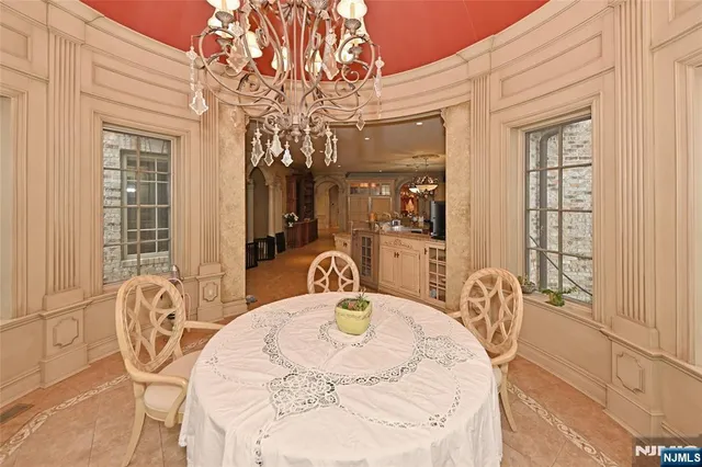 a view of a dining room with furniture and chandelier