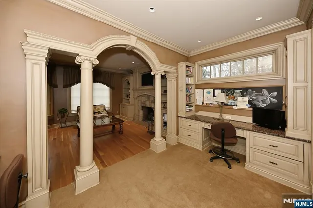 a view of a livingroom with workspace and a window