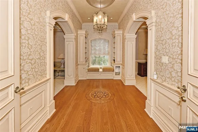 a spacious bathroom with a granite countertop shower a fireplace and a chandelier