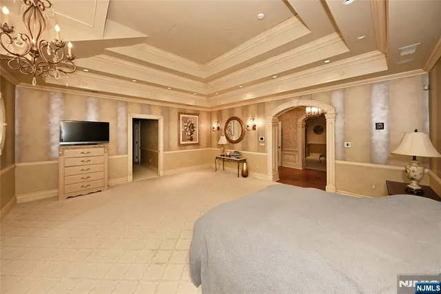 a bedroom with furniture and a flat screen tv